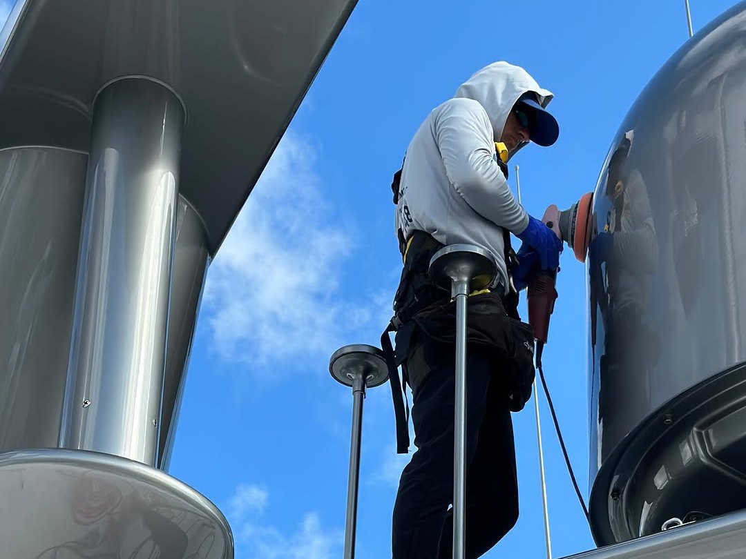 Two Correct Reflect technicians working aloft on a yacht radar arch in Miami